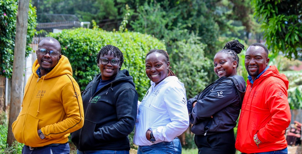 Spur Afrika team members wearing branded hoodies outdoors
